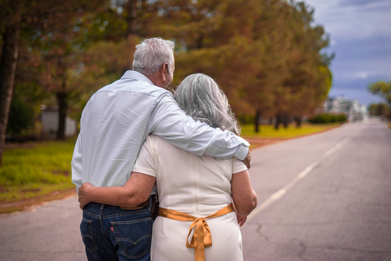 Older couple walking arm in arm outdoors
