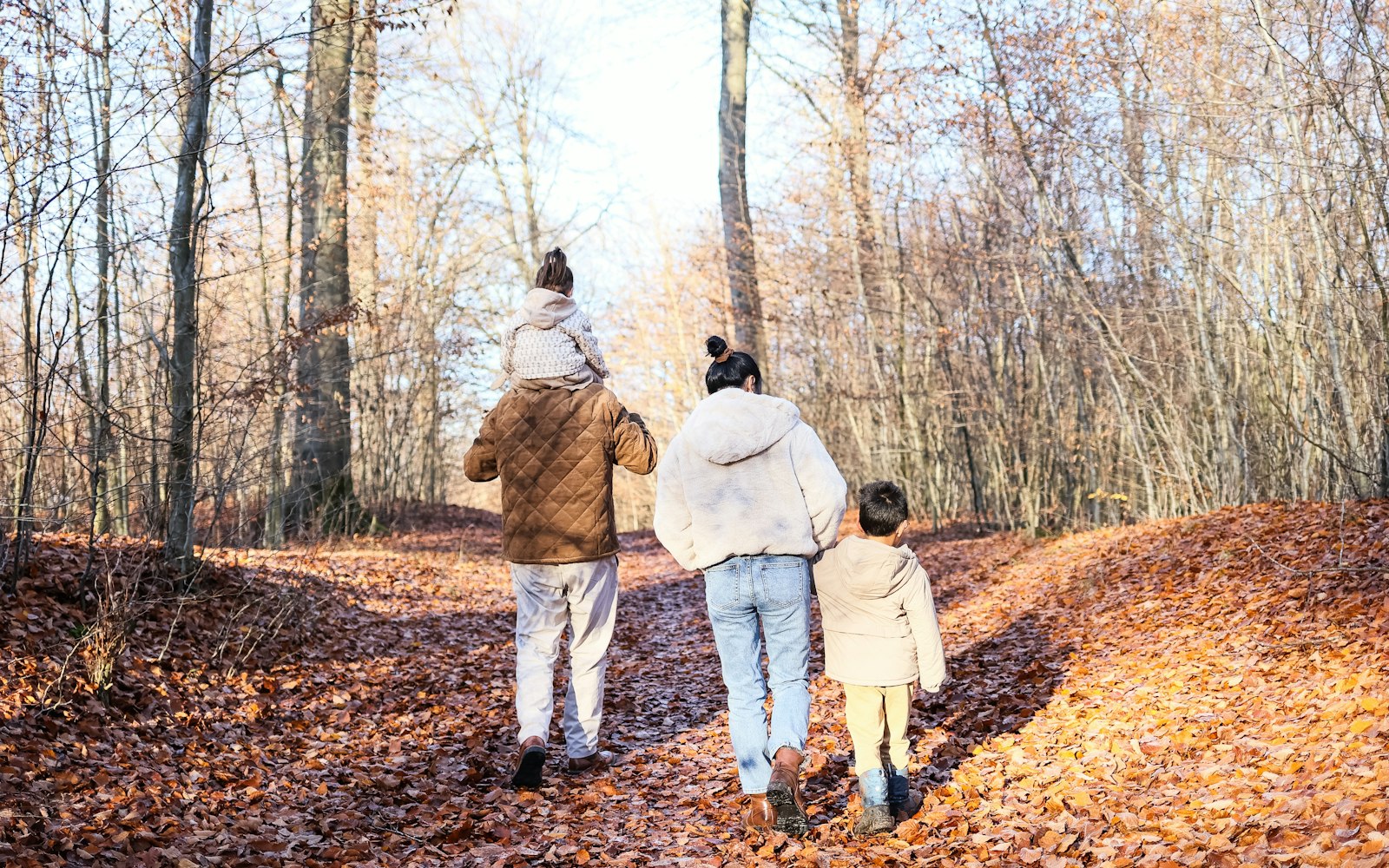 Family walking together through an autumn forest