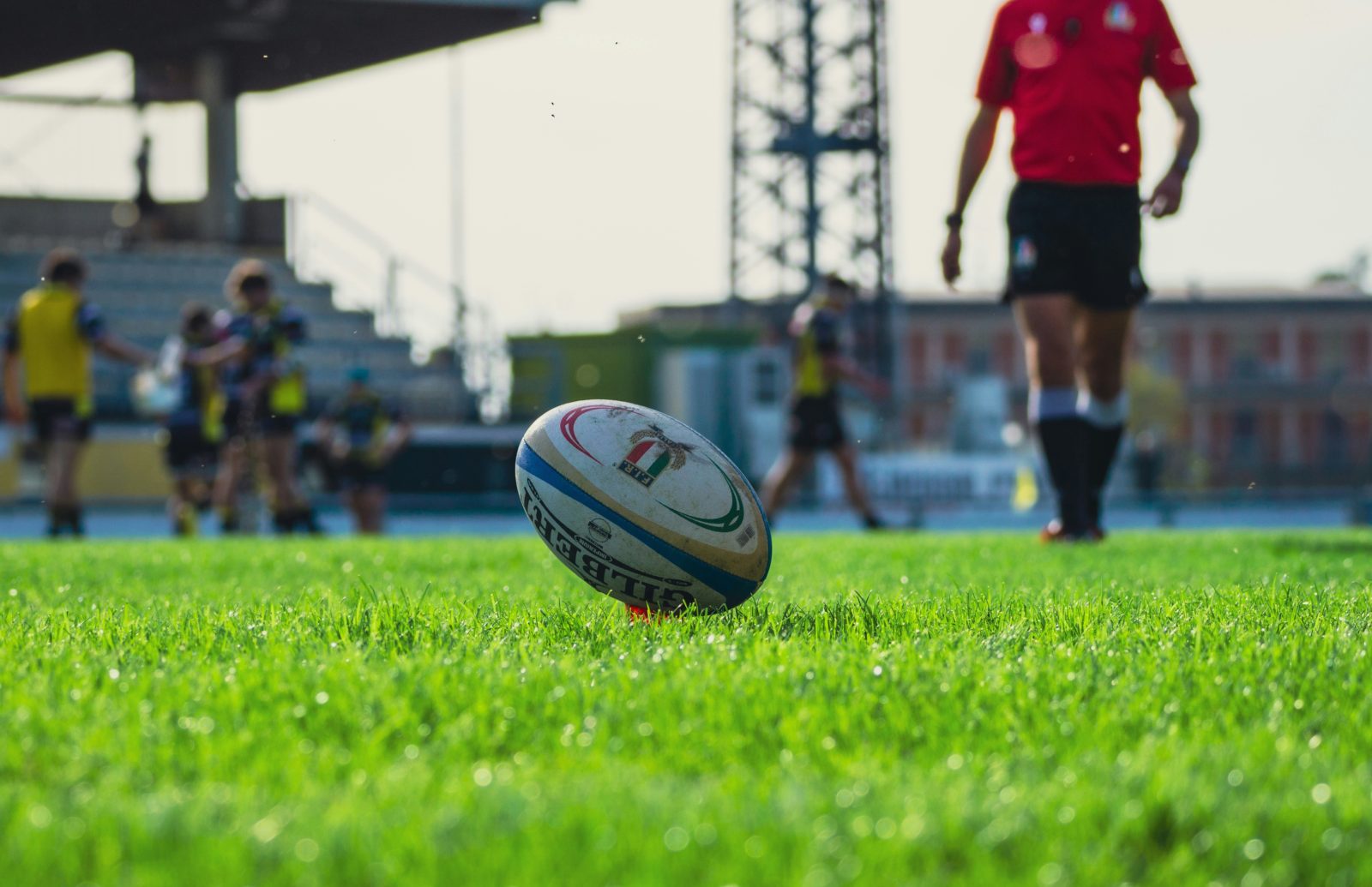 A rugby ball on the pitch during a match