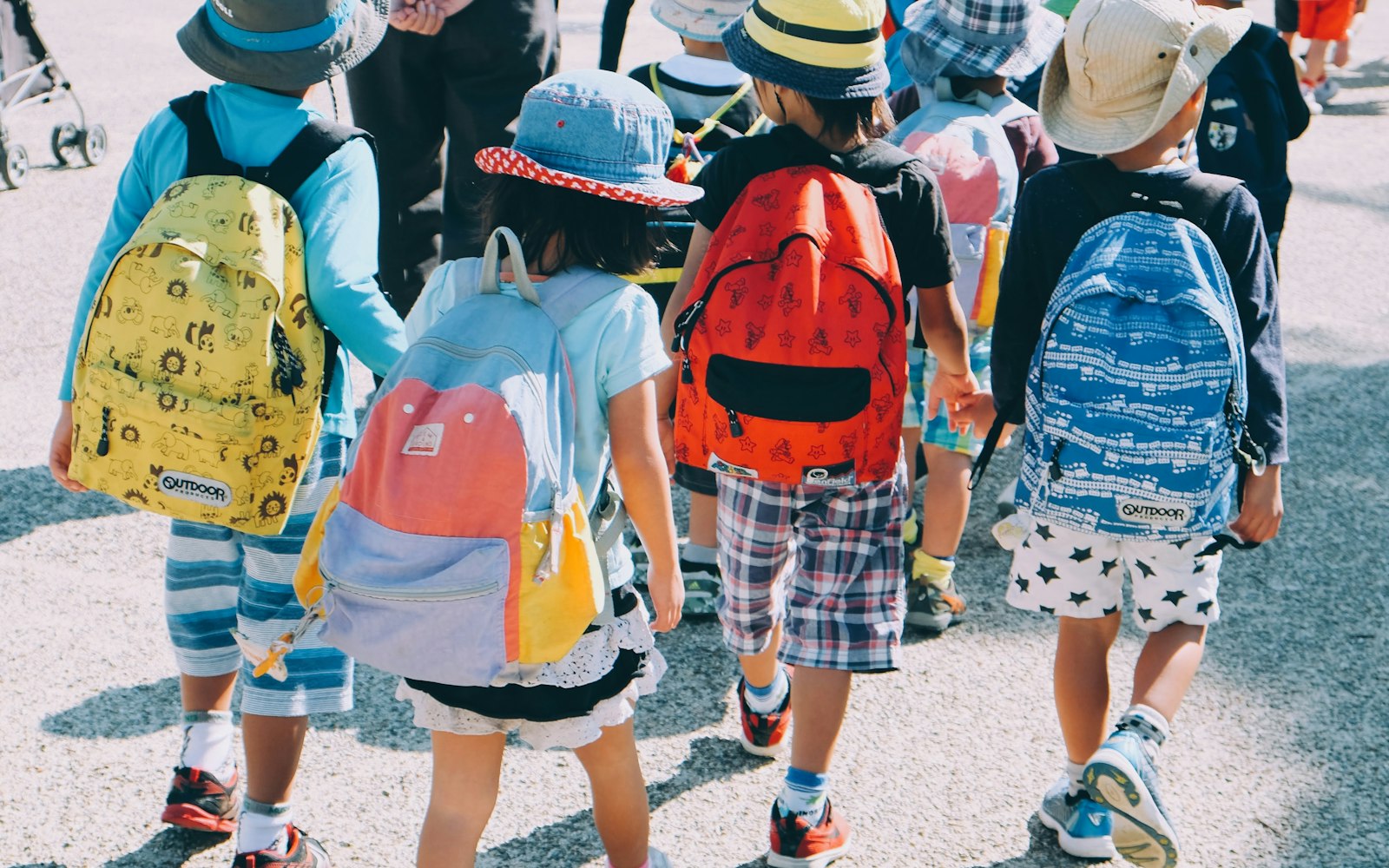 Young children with backpacks walking to school