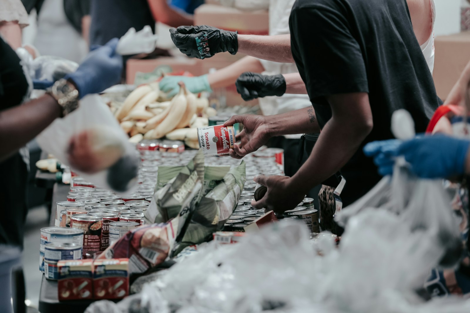 Volunteers sorting donated tins and food