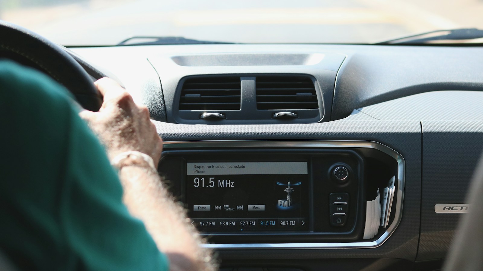 Driver's view of a car dashboard with a touchscreen radio
