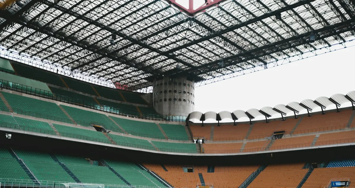 Empty stands and the steel roof of a large football stadium in Milan