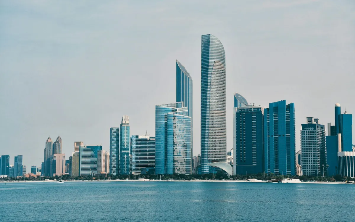 The Abu Dhabi skyline seen across calm blue water from the Corniche The Abu Dhabi skyline seen across calm blue water from the Corniche