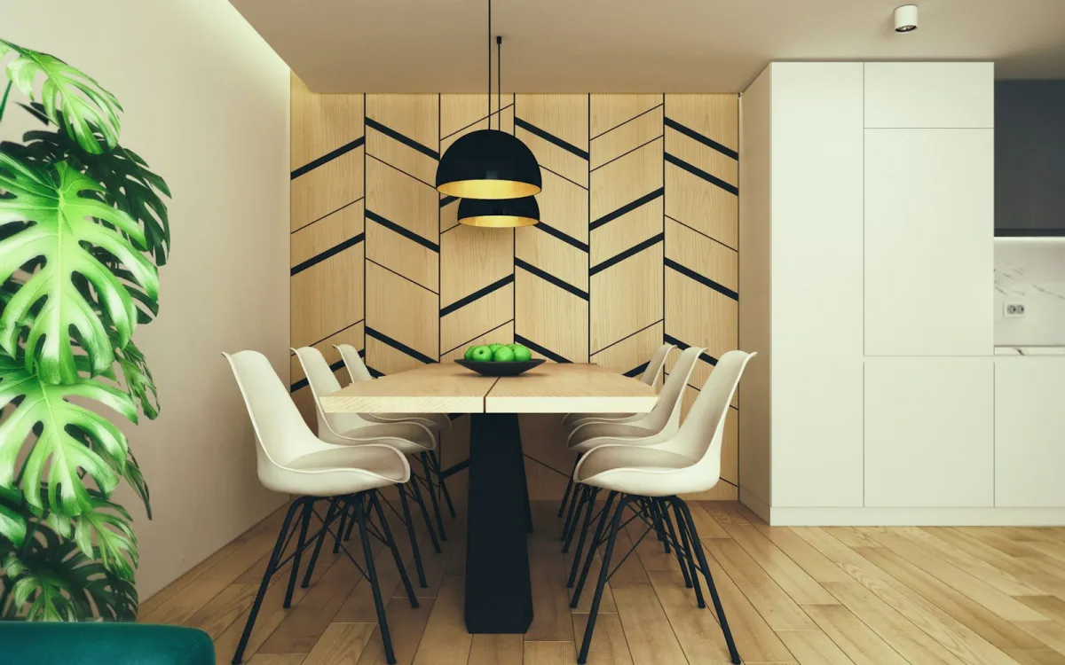 Two black dome pendant lights over a wooden dining table with white chairs