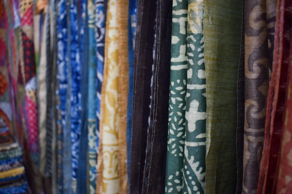 Rows of colourful block-printed fabrics hanging side by side in Delhi