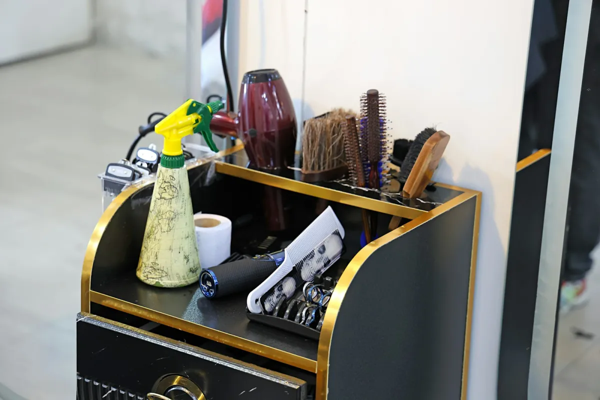 Hairdressing trolley with a hairdryer, brushes, combs and a spray bottle