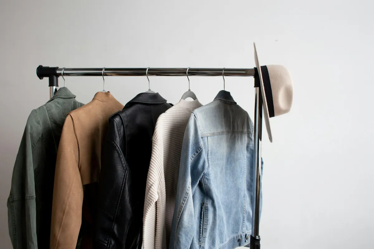 Five jackets and a felt hat hanging on a clothes rail