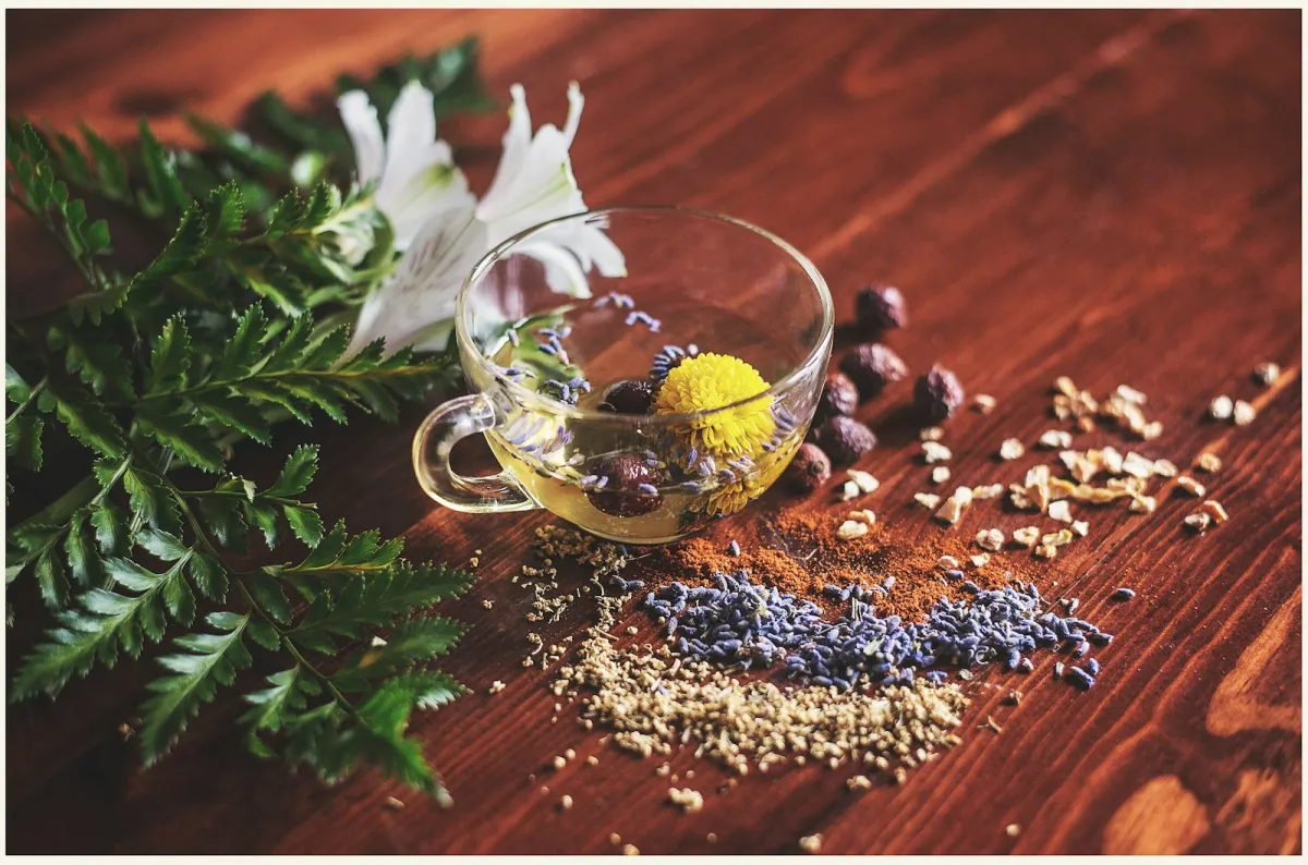 Glass cup of herbal tea on a wooden surface Glass cup of herbal tea on a wooden surface