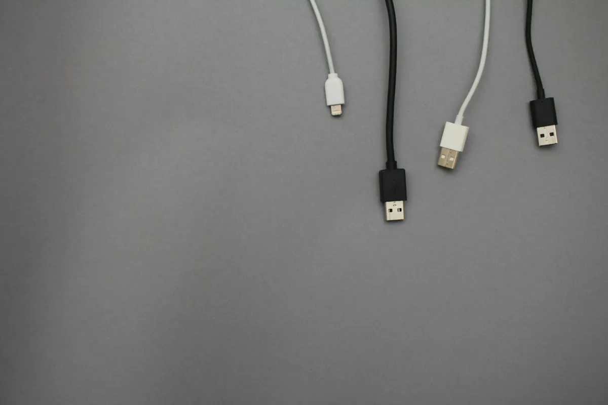 Black and white USB charging cables on a grey background