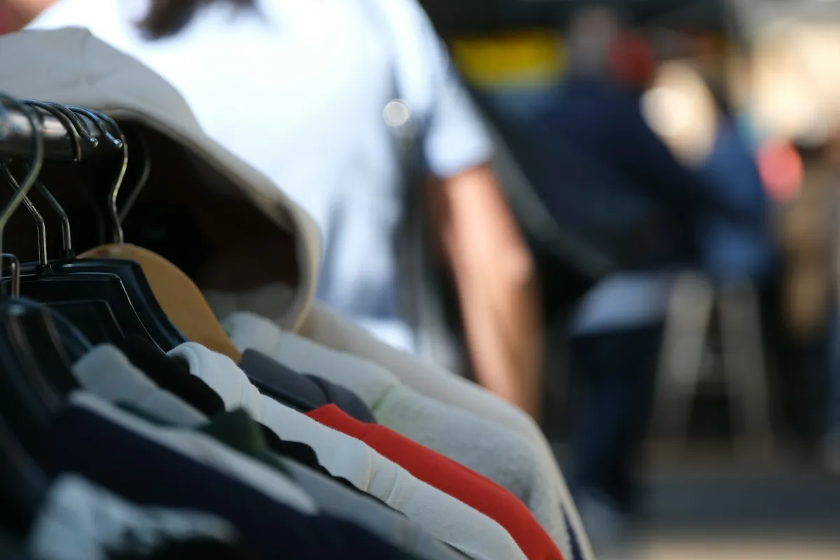 Row of shirts and jumpers hanging on a clothes rail Row of shirts and jumpers hanging on a clothes rail