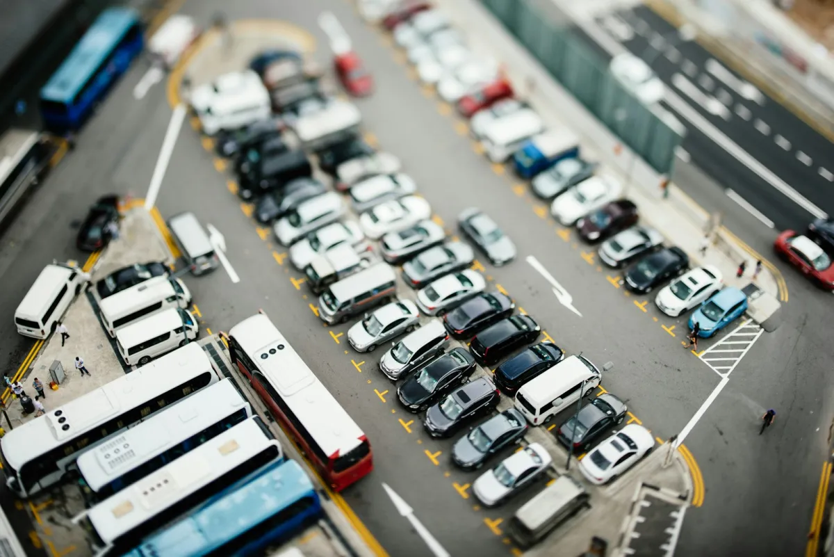 Aerial view of rows of cars, vans and coaches in a car park Aerial view of rows of cars, vans and coaches in a car park