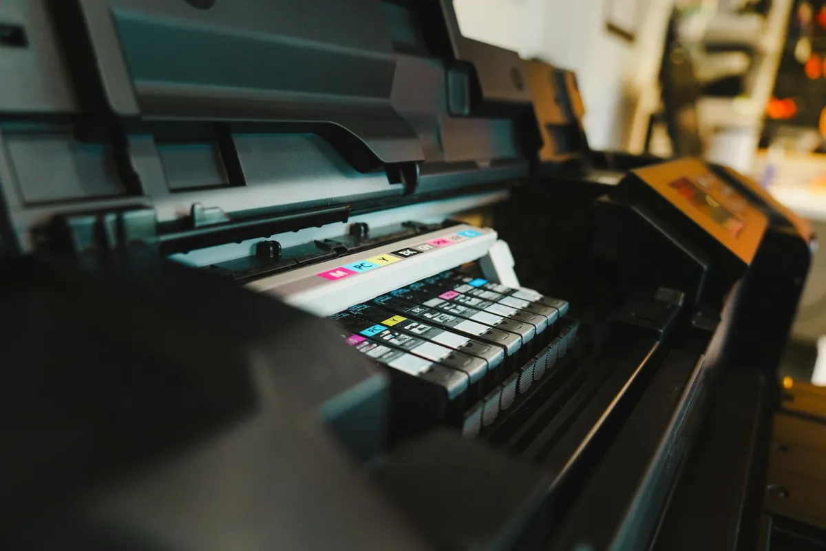 Ink cartridges loaded inside an open inkjet printer Ink cartridges loaded inside an open inkjet printer