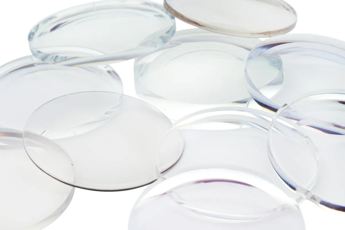 A pile of clear round lenses on a white surface A pile of clear round lenses on a white surface