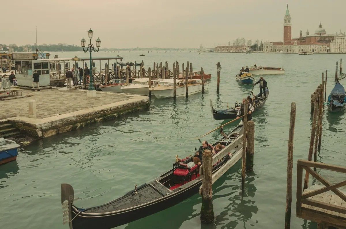 Gondolas and water taxis near St Mark's in Venice with San Giorgio Maggiore across the lagoon