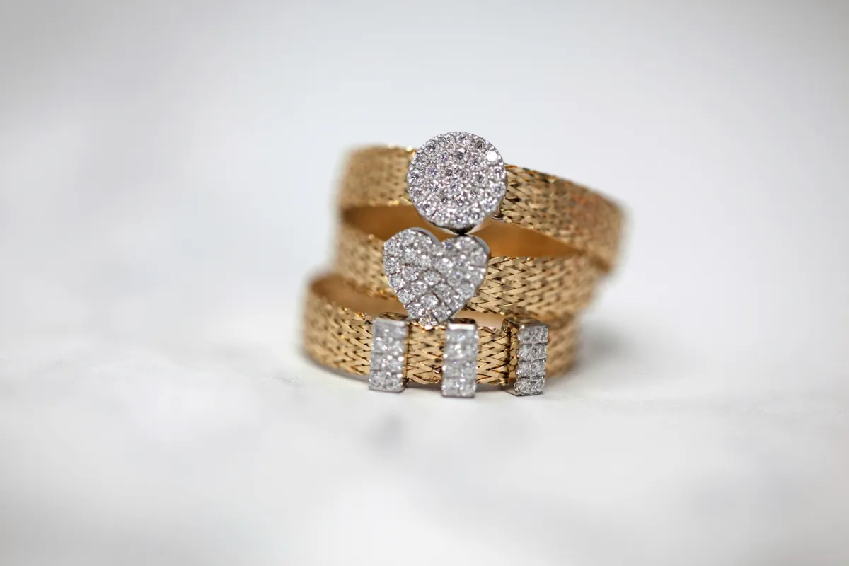 Three gold rings set with small stones