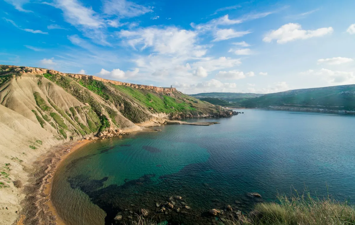 Clear blue water and green cliffs at Għajn Tuffieħa Bay near Mellieħa, Malta Clear blue water and green cliffs at Għajn Tuffieħa Bay near Mellieħa, Malta