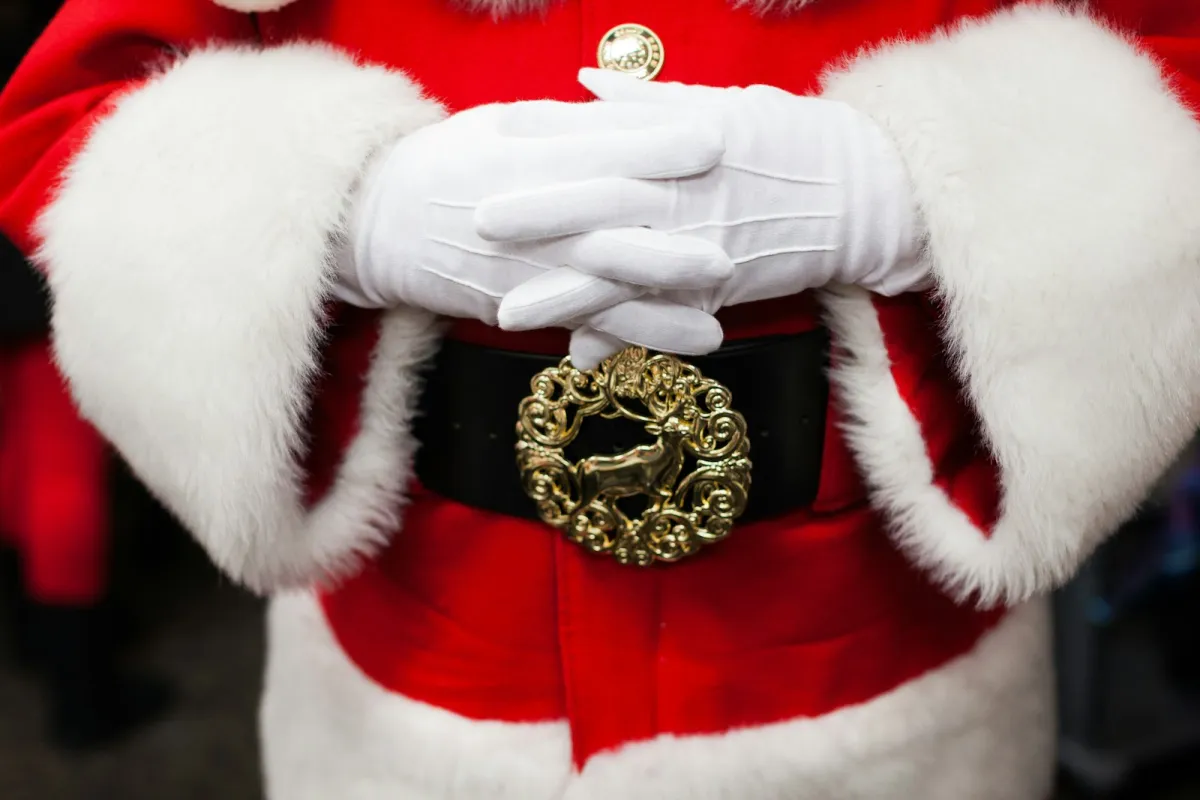 Close-up of a Santa Claus costume with white gloves and a gold belt buckle Close-up of a Santa Claus costume with white gloves and a gold belt buckle