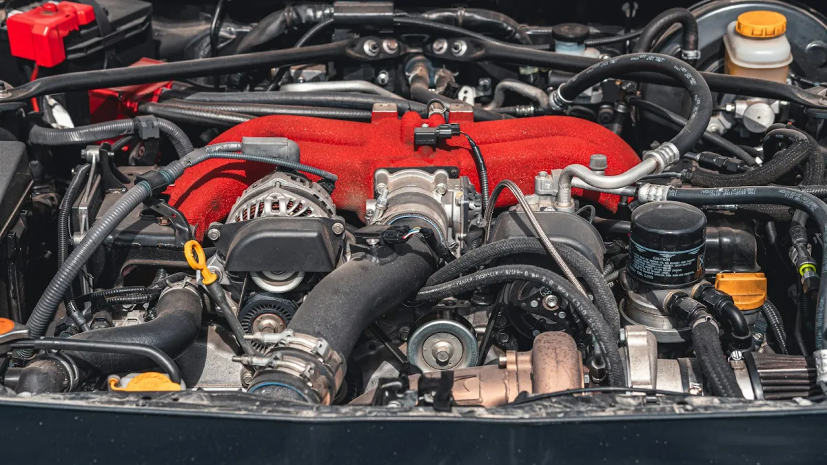 Engine bay of a modified car with a red intake manifold