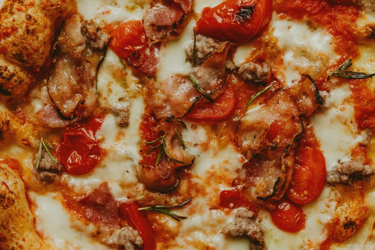 Pizza topped with tomatoes and melted cheese