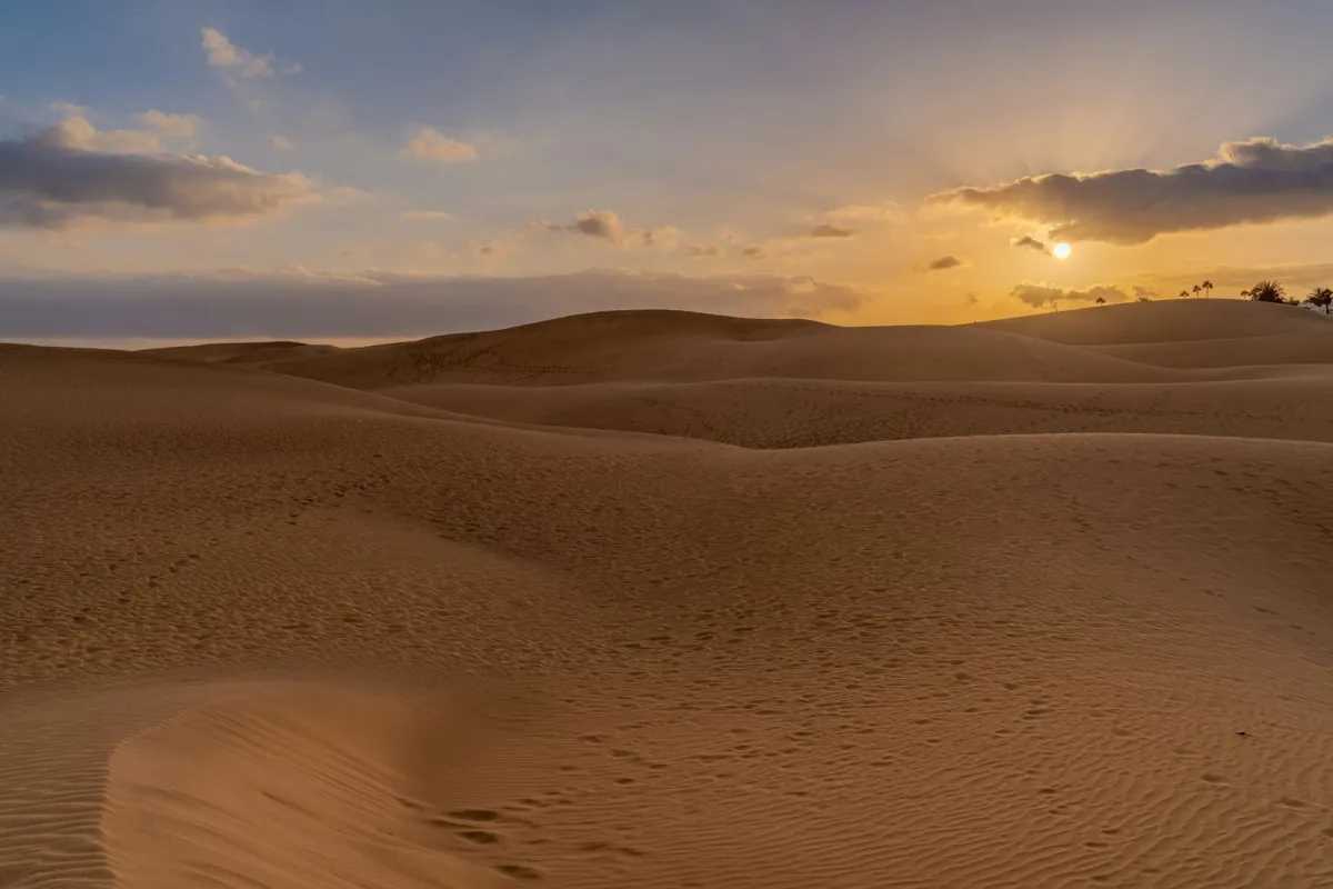 Sunset over the rolling sand dunes of Maspalomas in Gran Canaria Sunset over the rolling sand dunes of Maspalomas in Gran Canaria