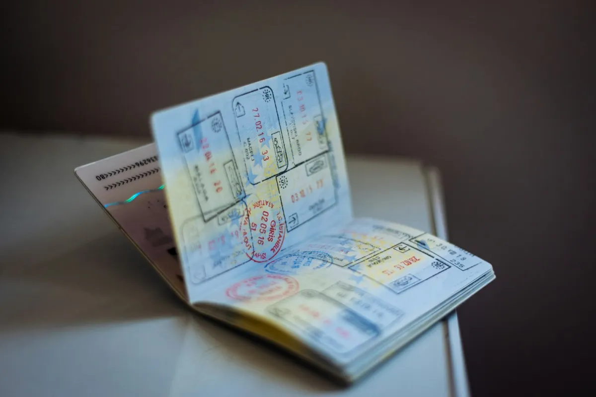 Open passport with pages full of ink entry and exit stamps Open passport with pages full of ink entry and exit stamps