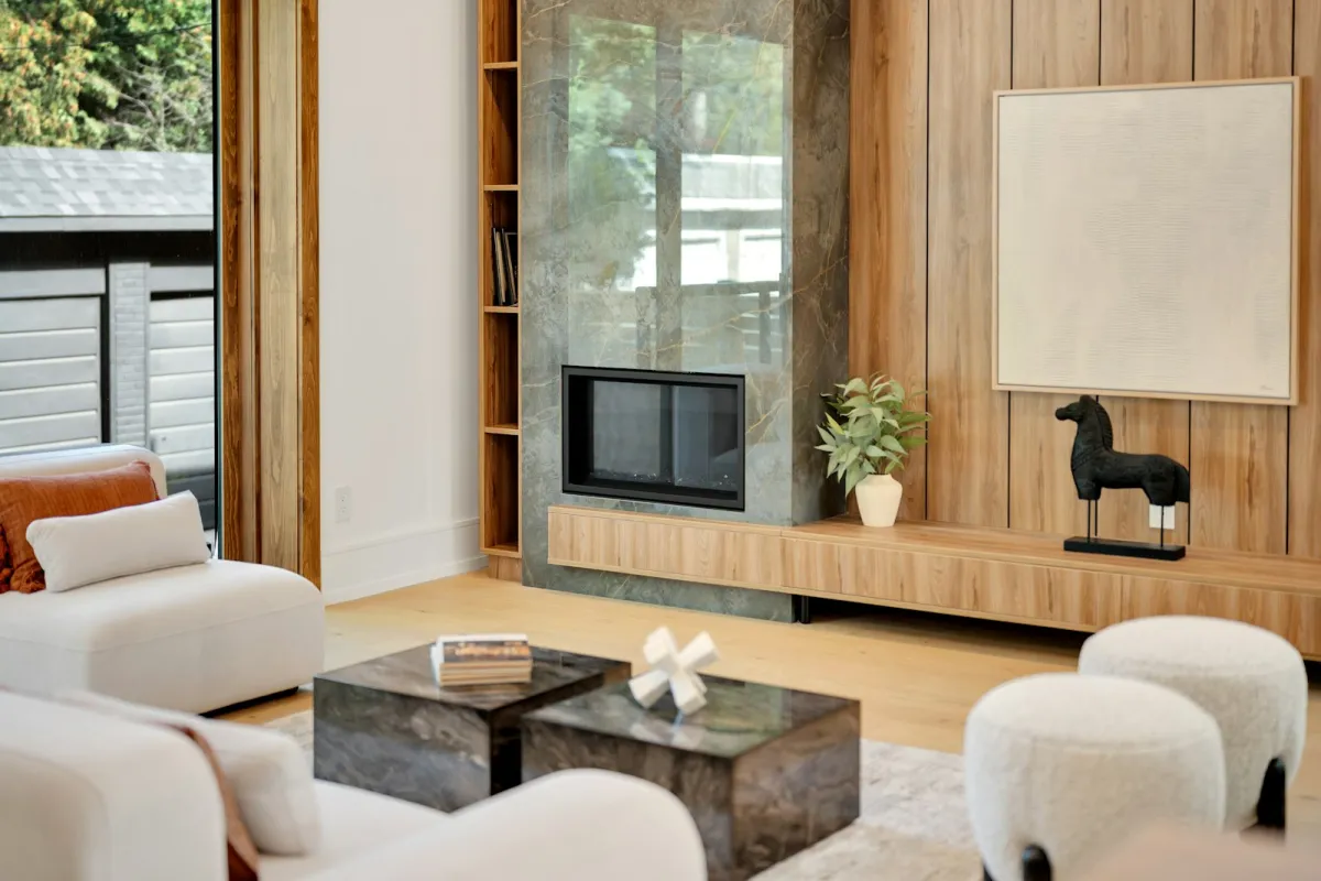 A modern living room with a built-in fireplace set in a stone wall