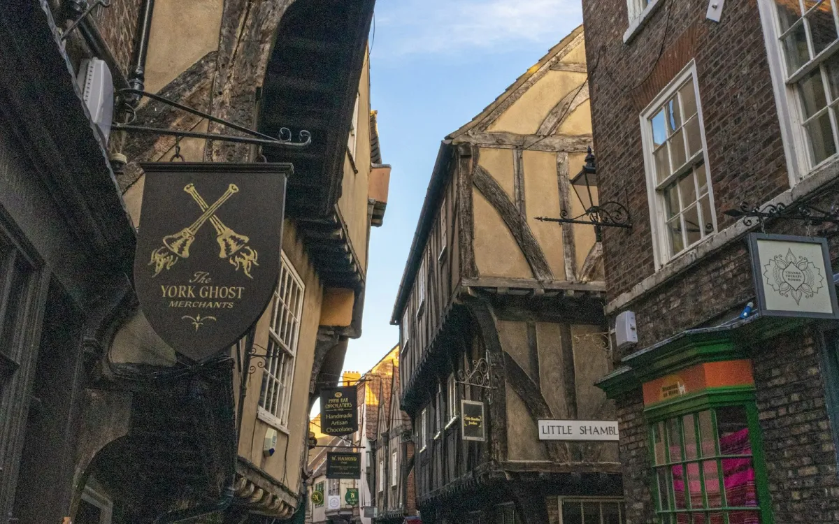 Timber-framed medieval buildings and hanging shop signs on the Shambles in York Timber-framed medieval buildings and hanging shop signs on the Shambles in York