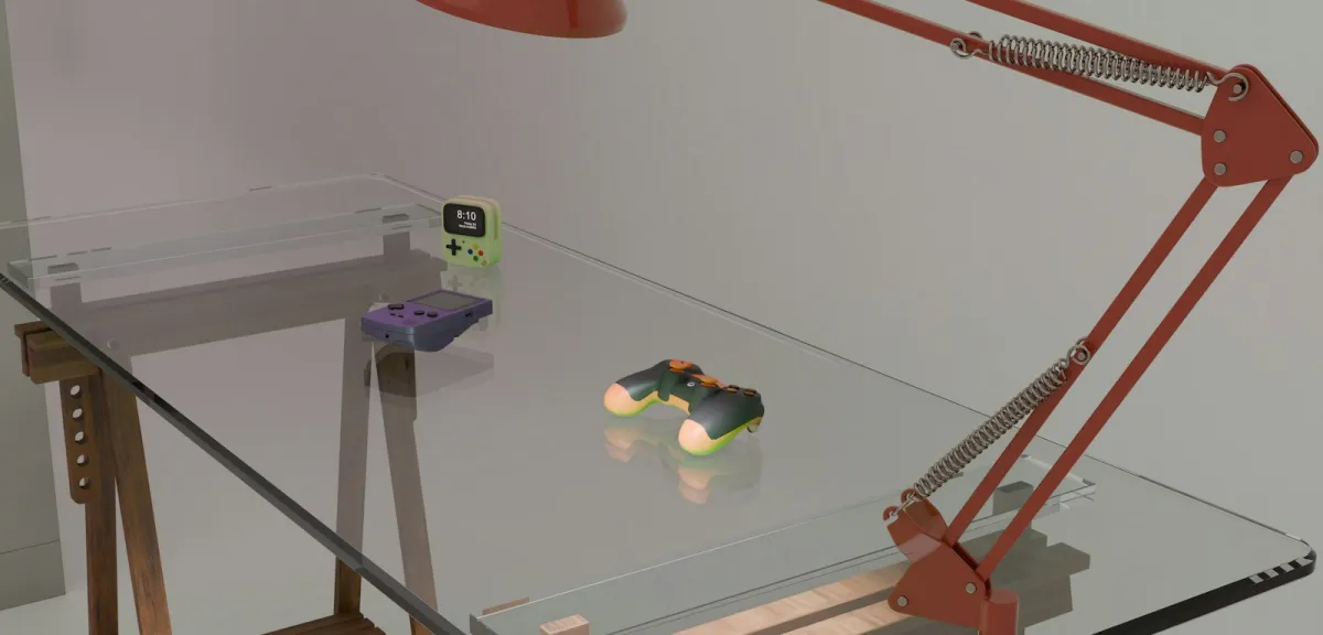 Game controllers and a handheld console on a glass desk beside a red lamp Game controllers and a handheld console on a glass desk beside a red lamp