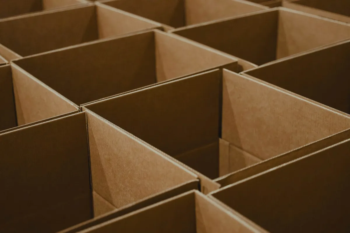 Rows of empty, open brown cardboard boxes packed tightly together