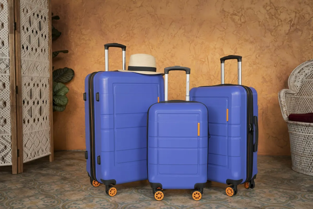 Three blue hard-shell suitcases of different sizes standing together Three blue hard-shell suitcases of different sizes standing together