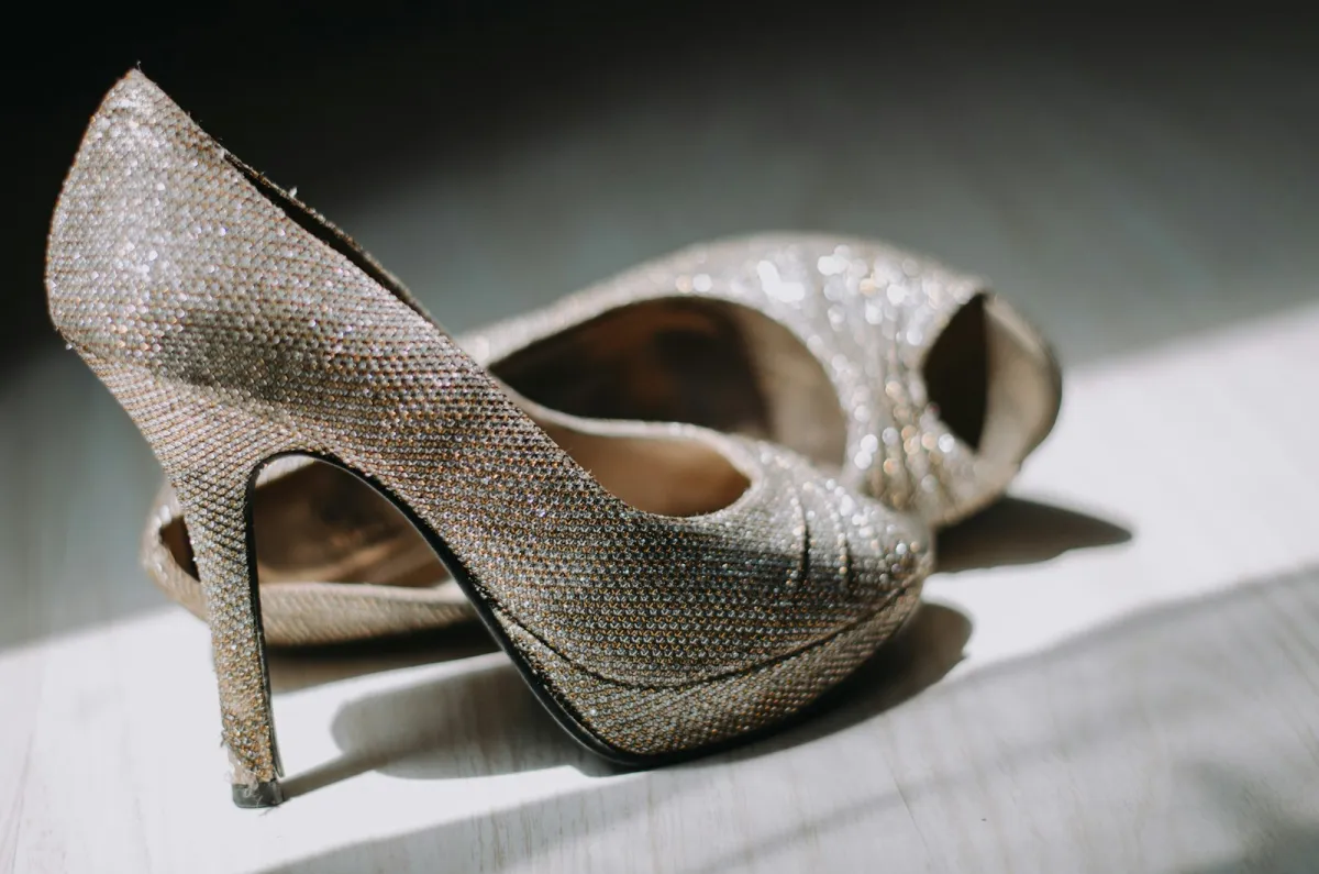 A pair of sparkly silver platform stilettos in a patch of sunlight A pair of sparkly silver platform stilettos in a patch of sunlight