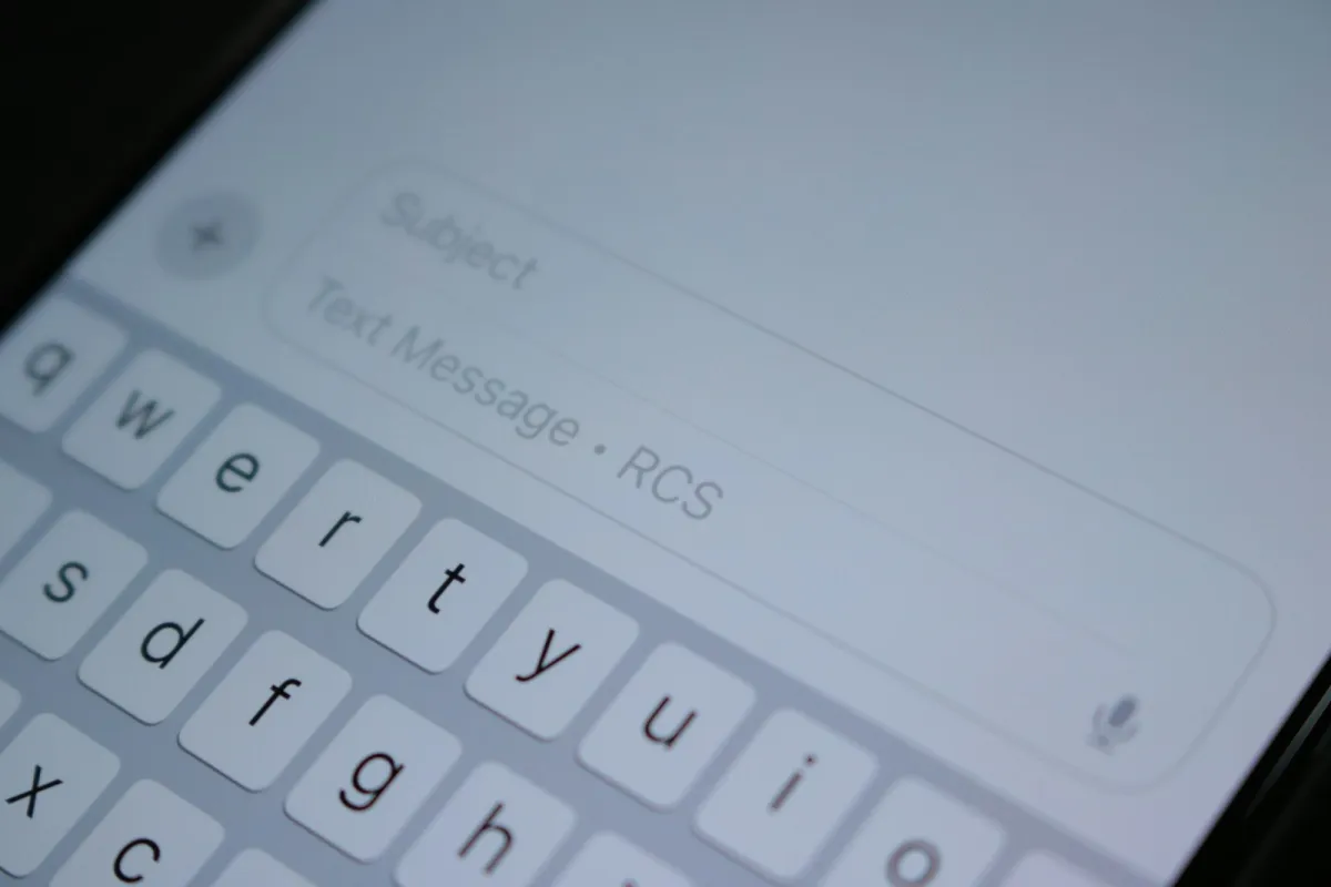 Close-up of a phone's text message box and keyboard Close-up of a phone's text message box and keyboard