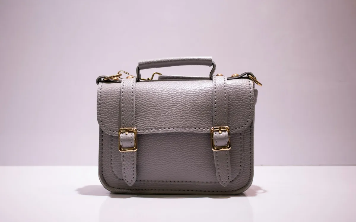 Grey leather top-handle satchel with gold buckles