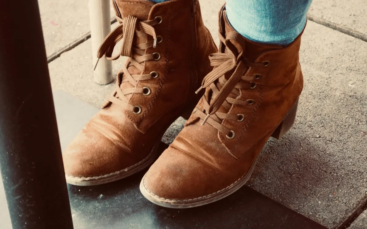 Brown suede lace-up ankle boots worn with jeans Brown suede lace-up ankle boots worn with jeans