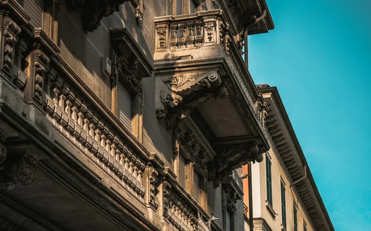 Ornate baroque balconies on a building in Novara under a blue sky Ornate baroque balconies on a building in Novara under a blue sky