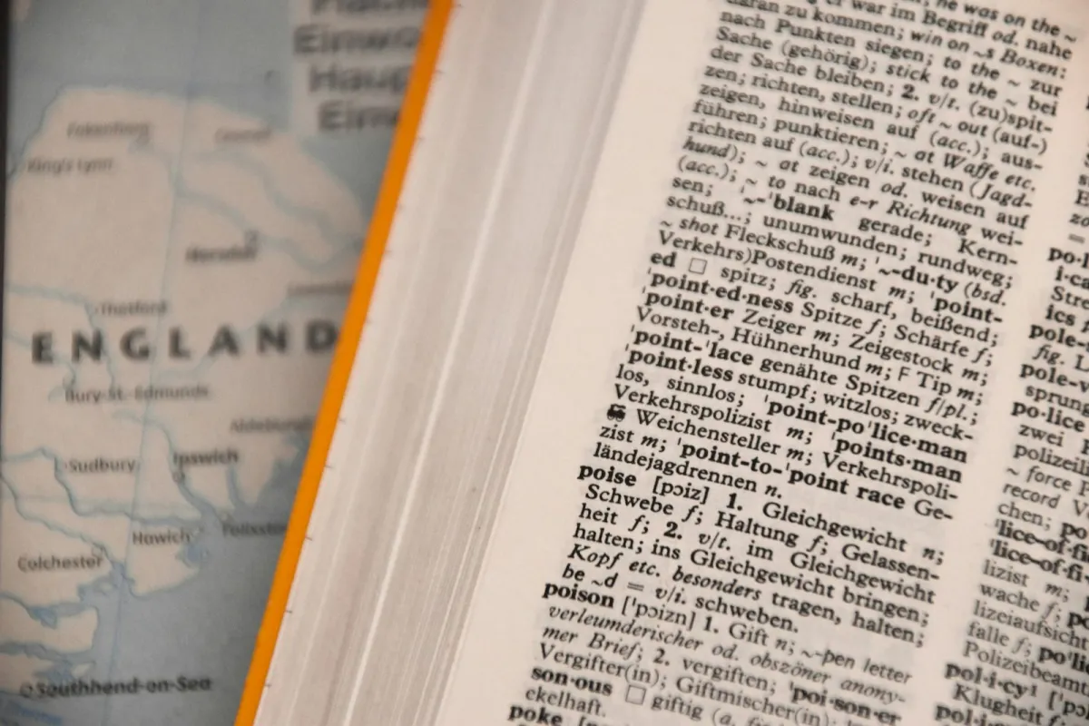 An open English dictionary lying flat in natural light An open English dictionary lying flat in natural light