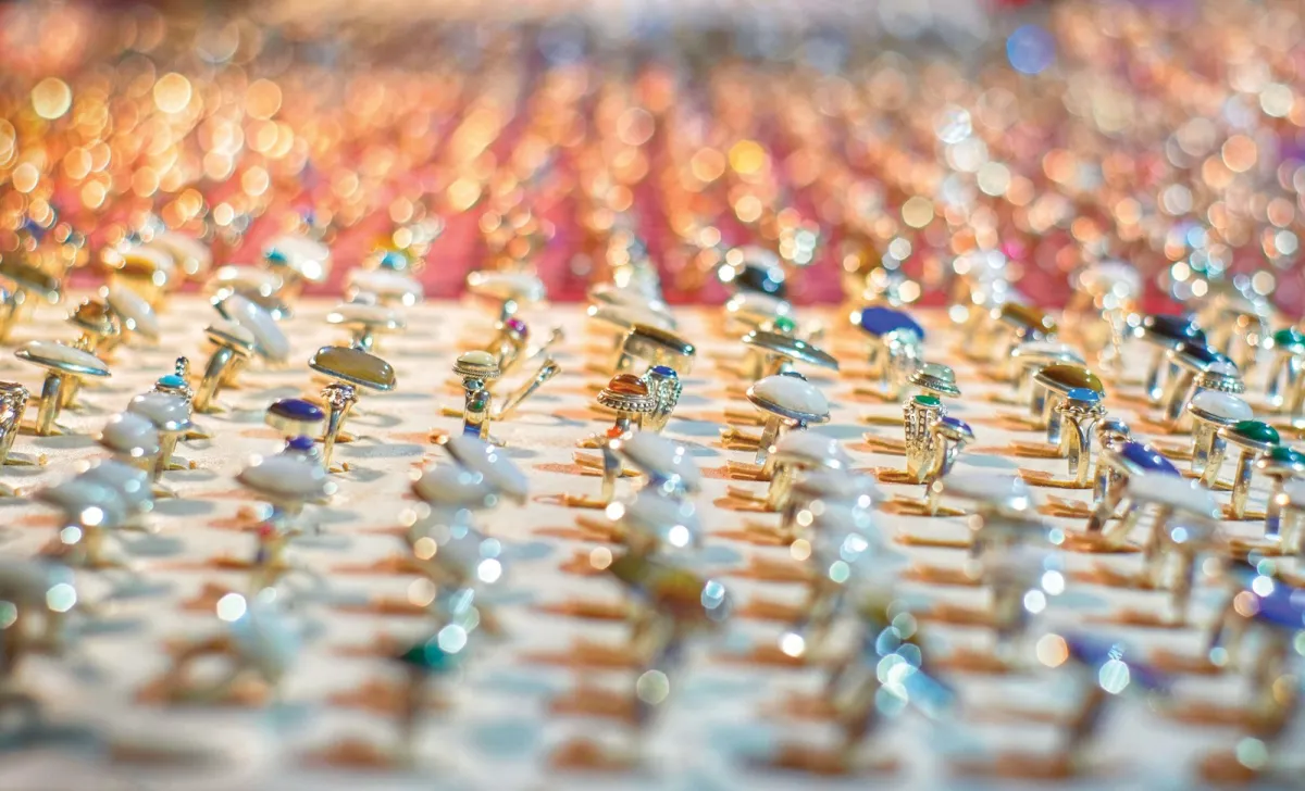 Rows of silver rings set with coloured stones on a display Rows of silver rings set with coloured stones on a display