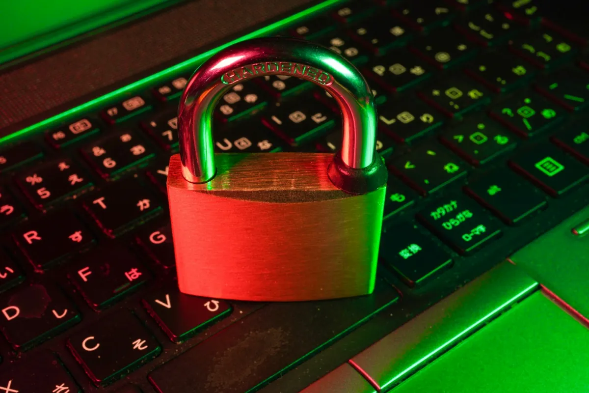A red padlock resting on a black computer keyboard A red padlock resting on a black computer keyboard
