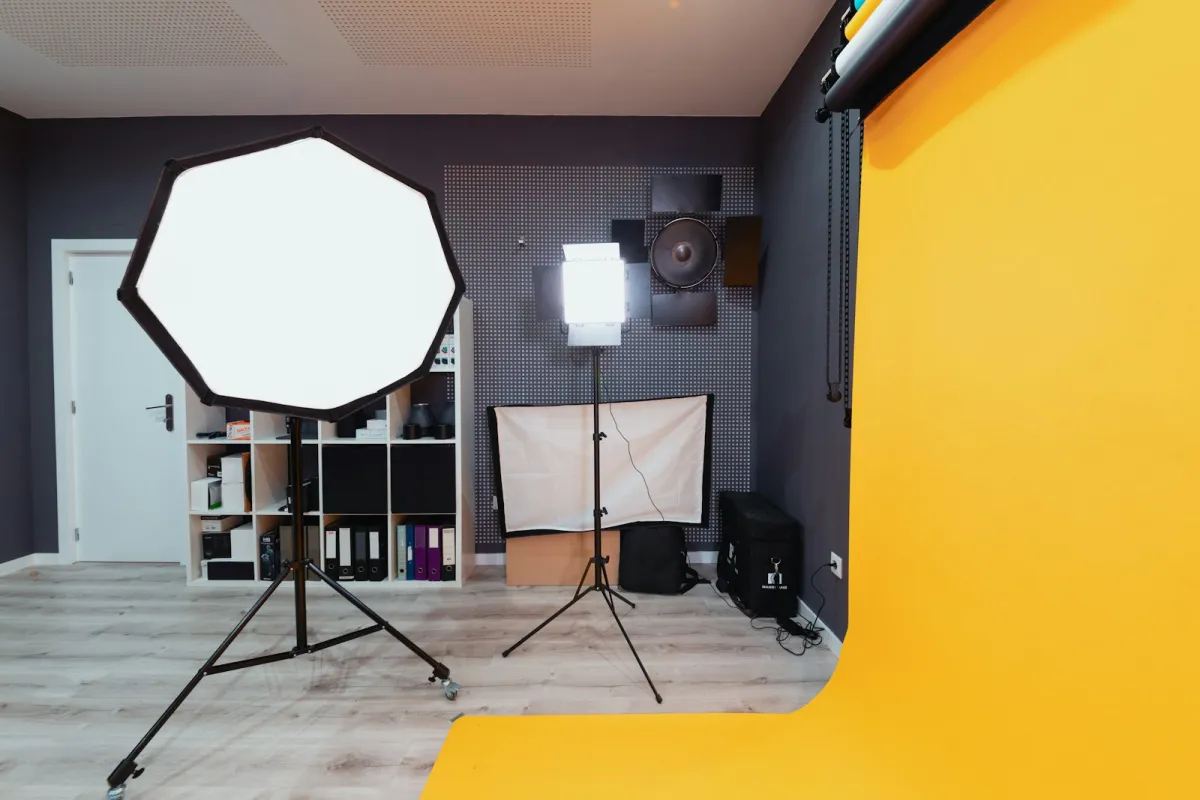 A photo studio with an octagonal softbox, LED light and yellow paper backdrop A photo studio with an octagonal softbox, LED light and yellow paper backdrop