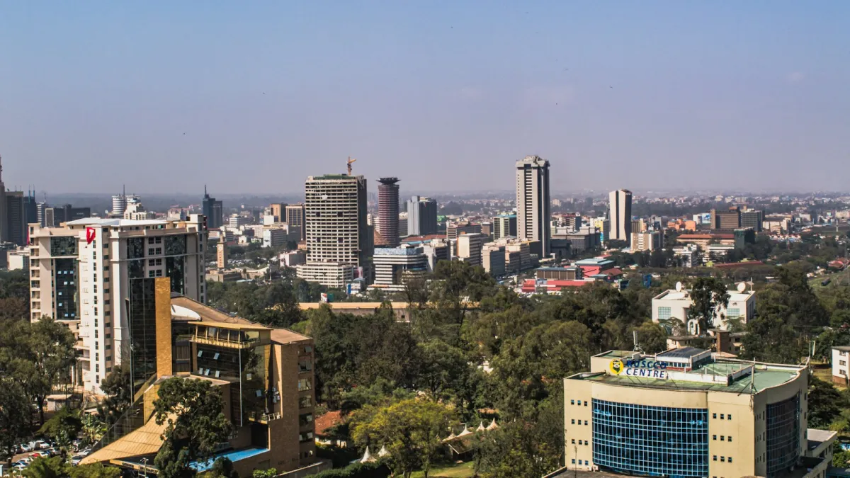 The Nairobi skyline on a sunny day, with tower blocks rising above green trees The Nairobi skyline on a sunny day, with tower blocks rising above green trees
