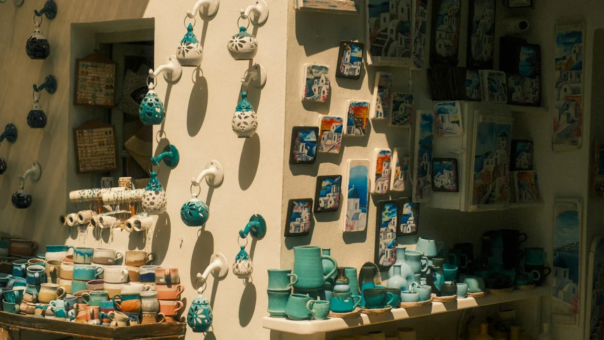 Handmade ceramic mugs, jugs and hanging lanterns on display in a sunlit shop