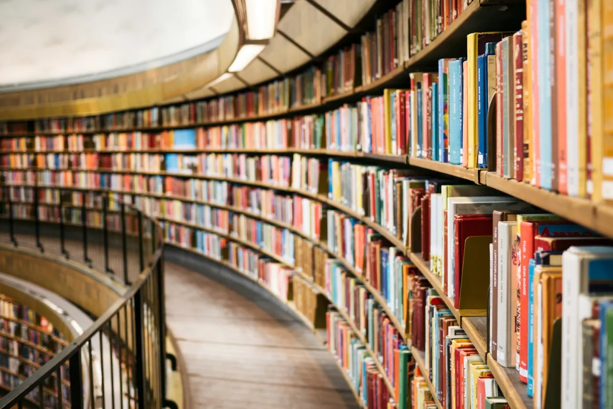 Curved library shelves filled with colourful books