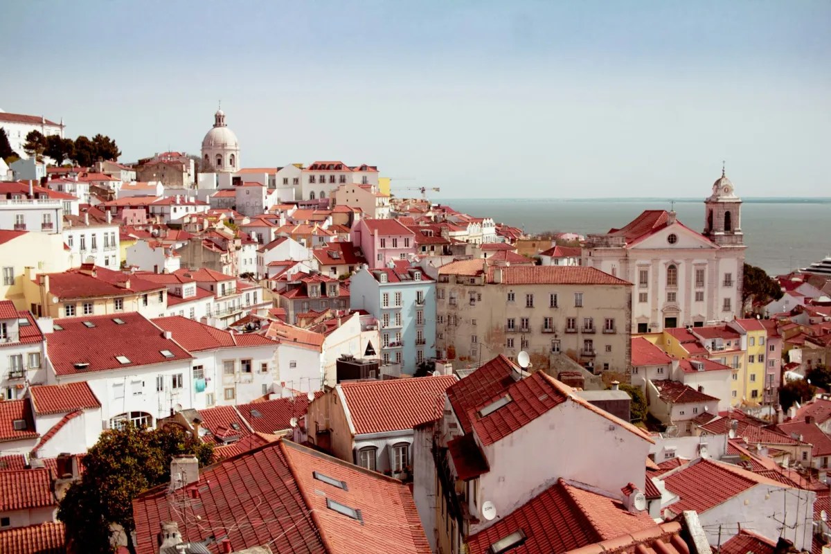 Red-tiled rooftops of Lisbon's Alfama district stretching down to the River Tagus Red-tiled rooftops of Lisbon's Alfama district stretching down to the River Tagus