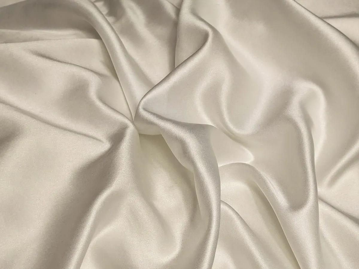 Soft folds of white silk fabric