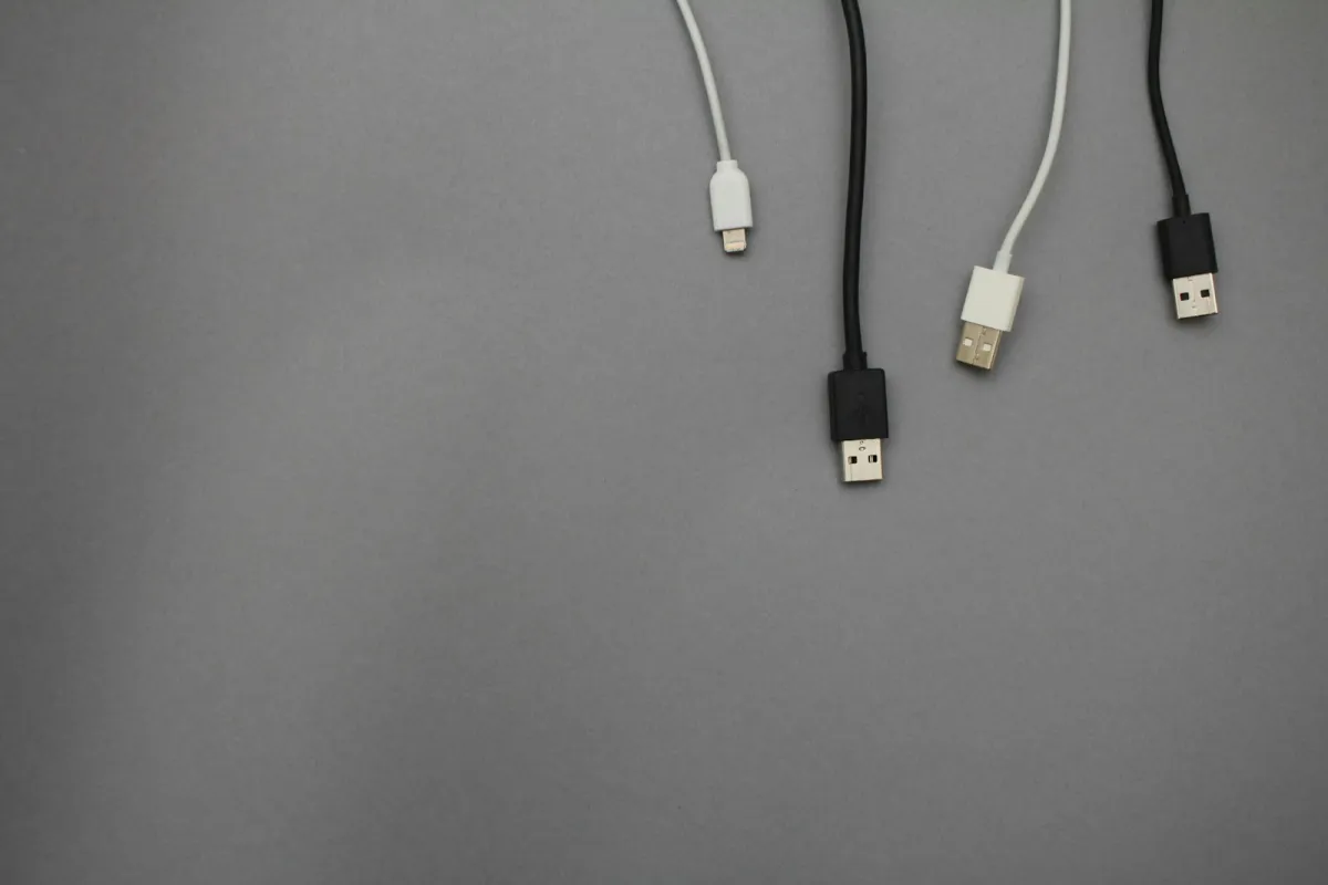 Black and white USB charging cables on a grey background Black and white USB charging cables on a grey background