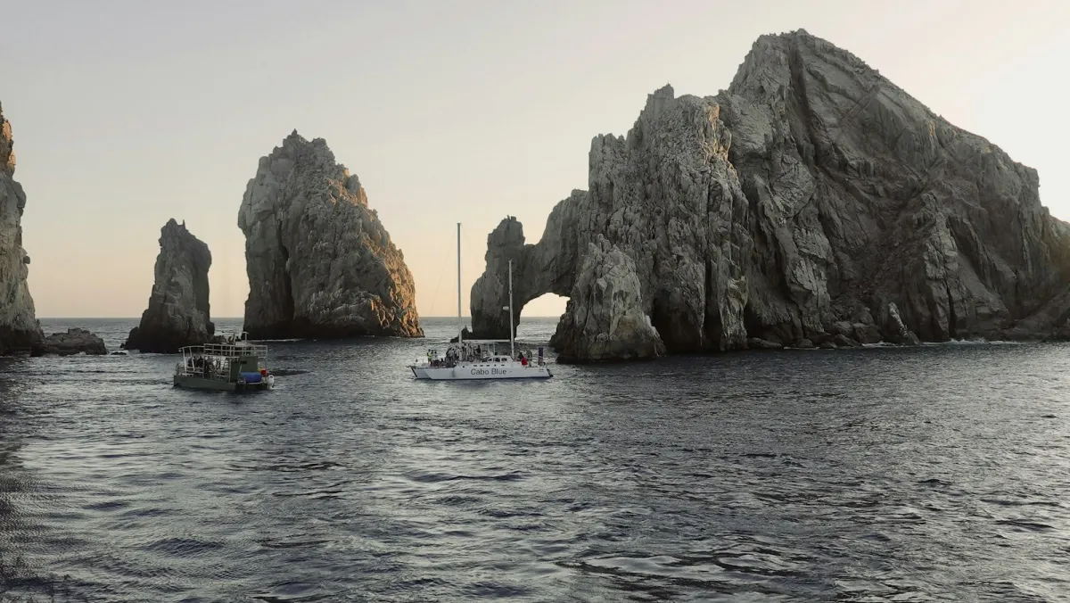 Boats beside the rock arch at Land's End, Cabo San Lucas Boats beside the rock arch at Land's End, Cabo San Lucas