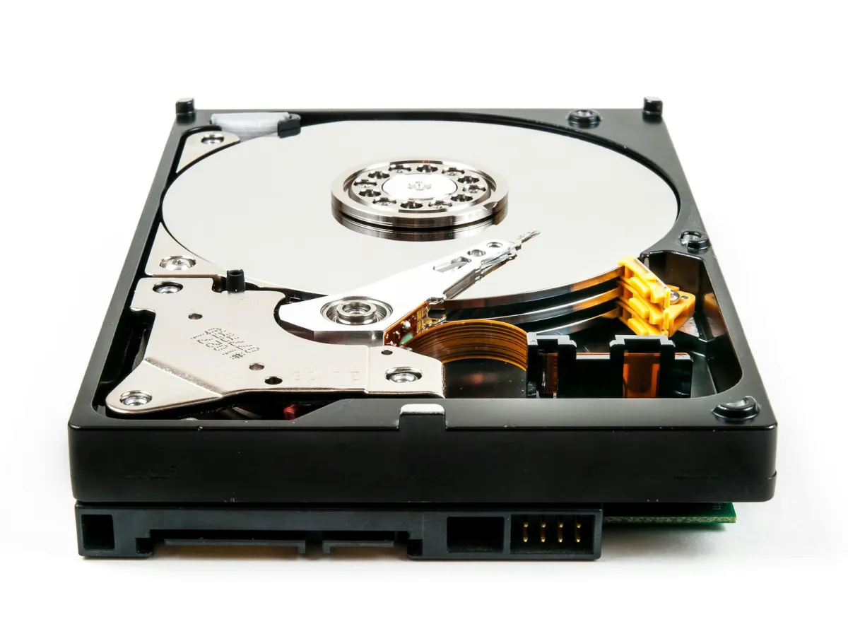 An opened hard disk drive showing its platter and read arm An opened hard disk drive showing its platter and read arm