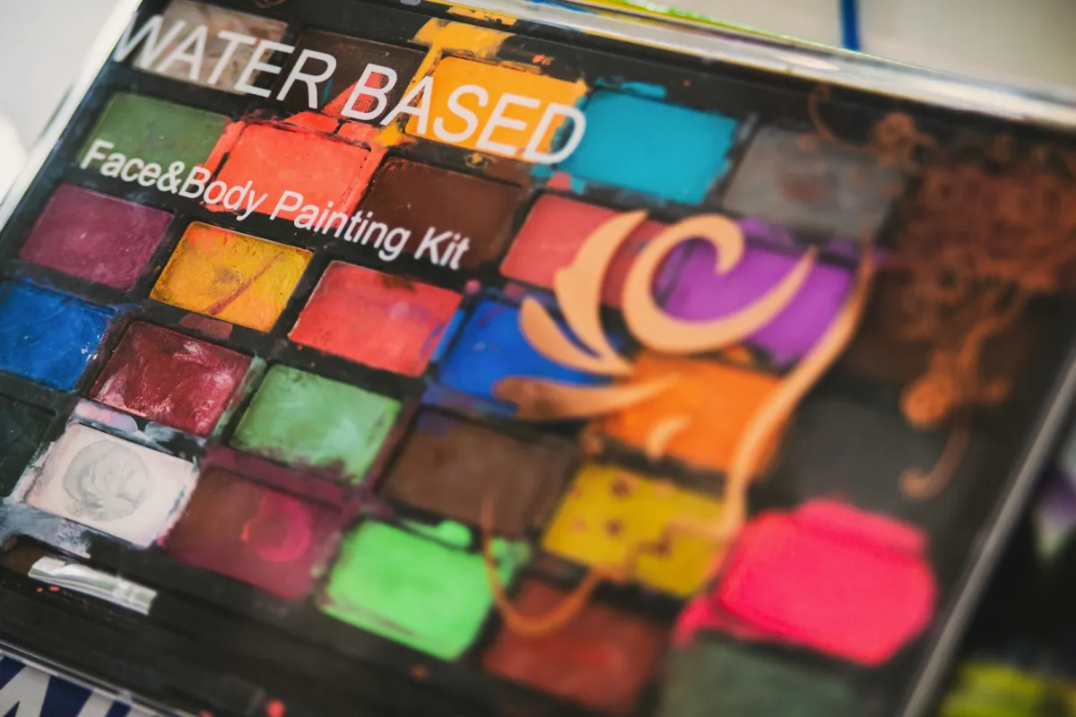 A well-used face and body painting kit with blocks of bright colours A well-used face and body painting kit with blocks of bright colours