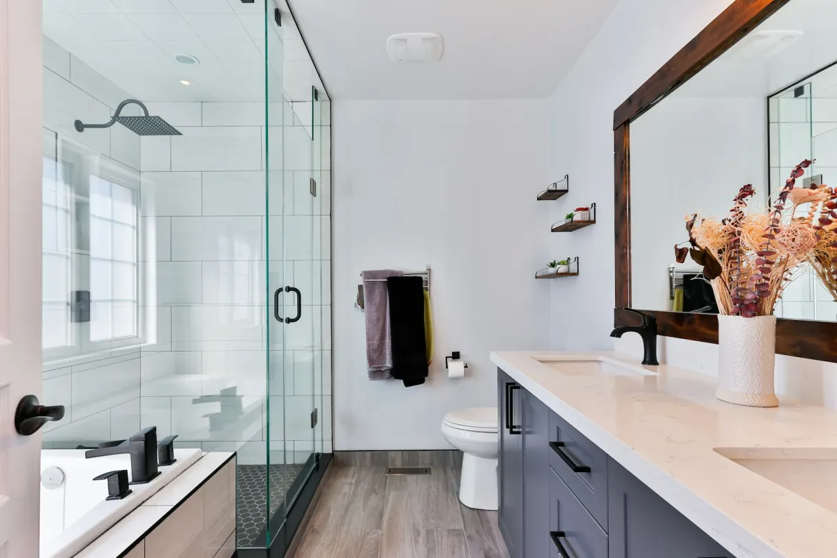 Bright modern bathroom with glass shower, toilet and double vanity Bright modern bathroom with glass shower, toilet and double vanity